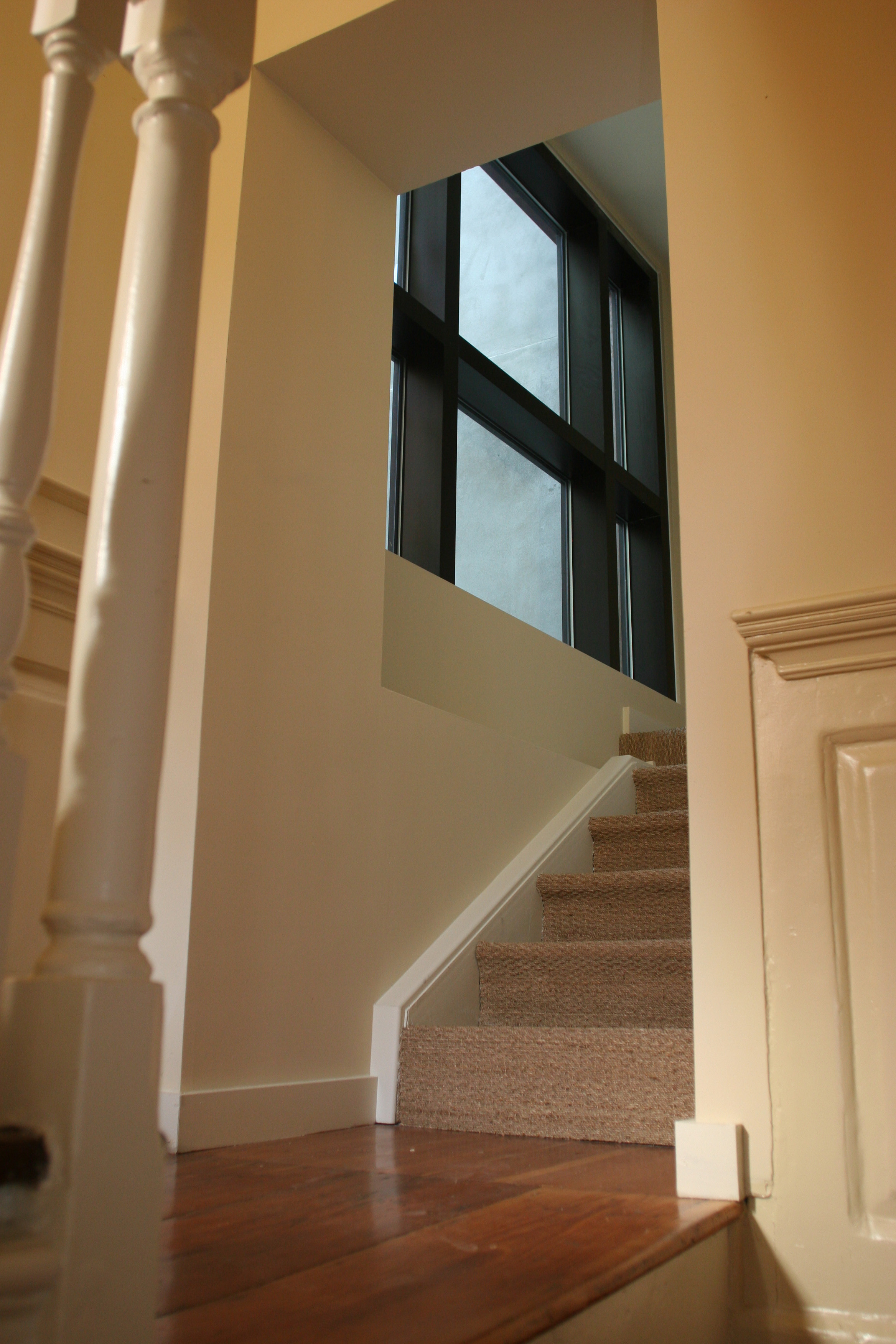 looking up stairway to new stairs and window